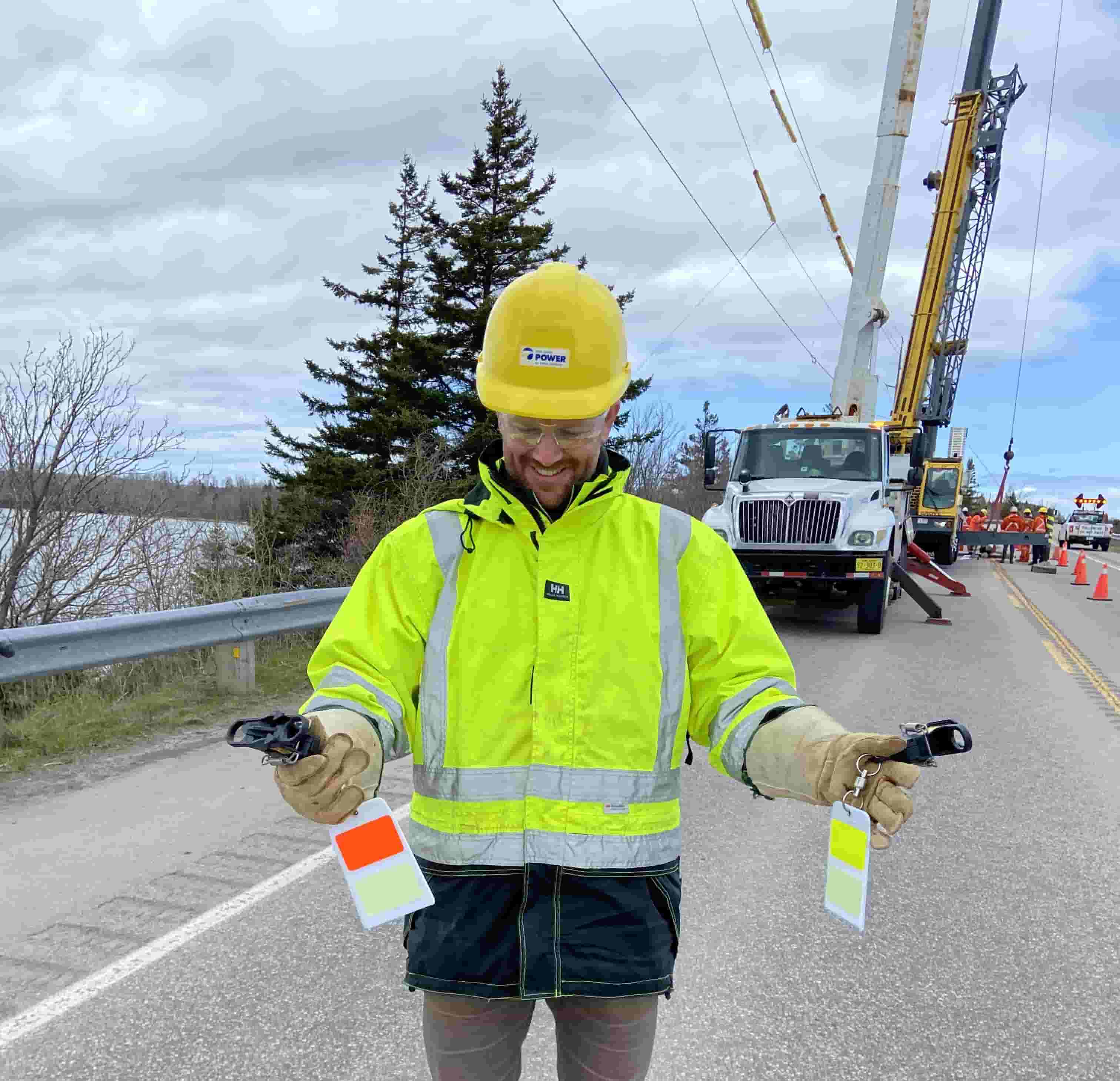 A NS Power worker overseeing the installation of environmental protection devices on a road