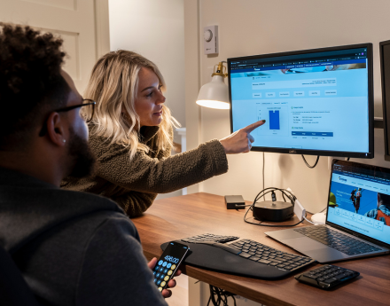 A couple viewing their bill on a computer