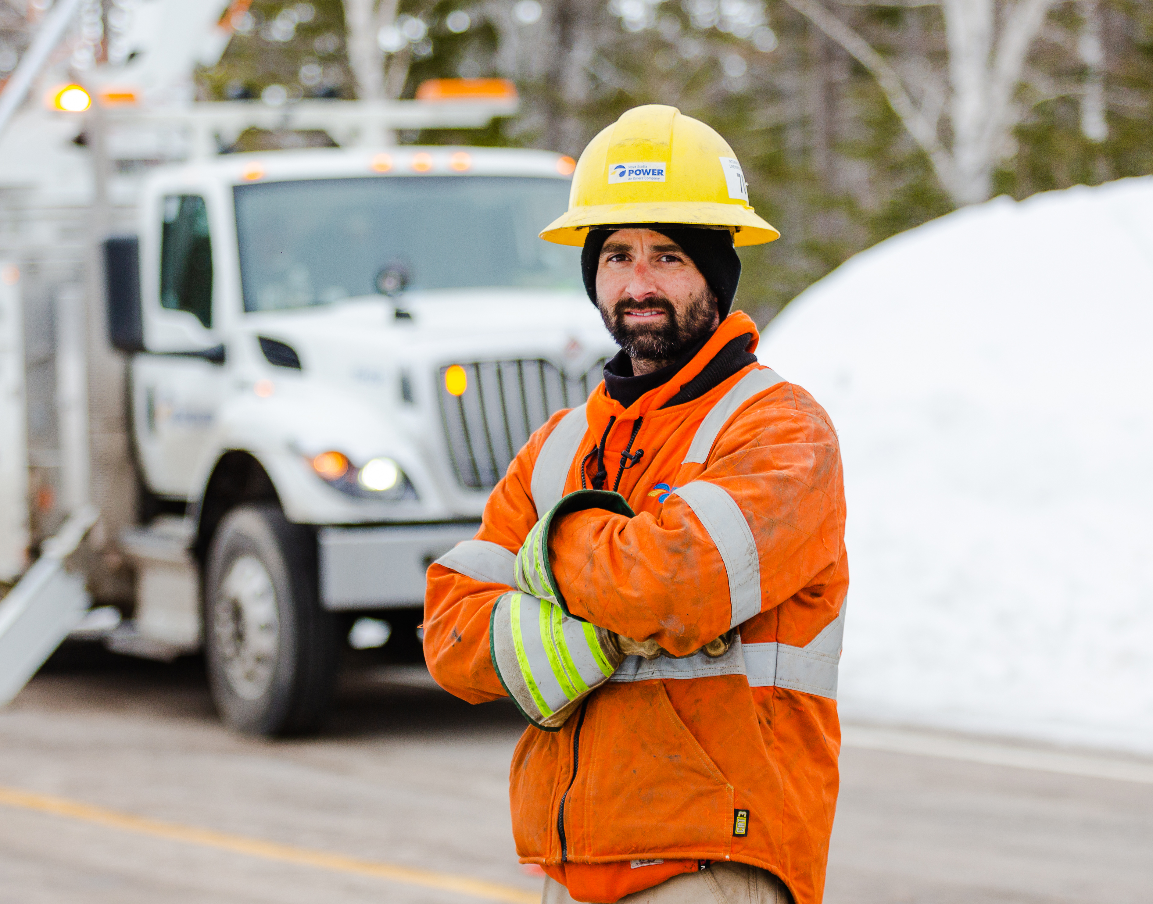 An electrical engineer crossing his arm and smiling in Ingonish