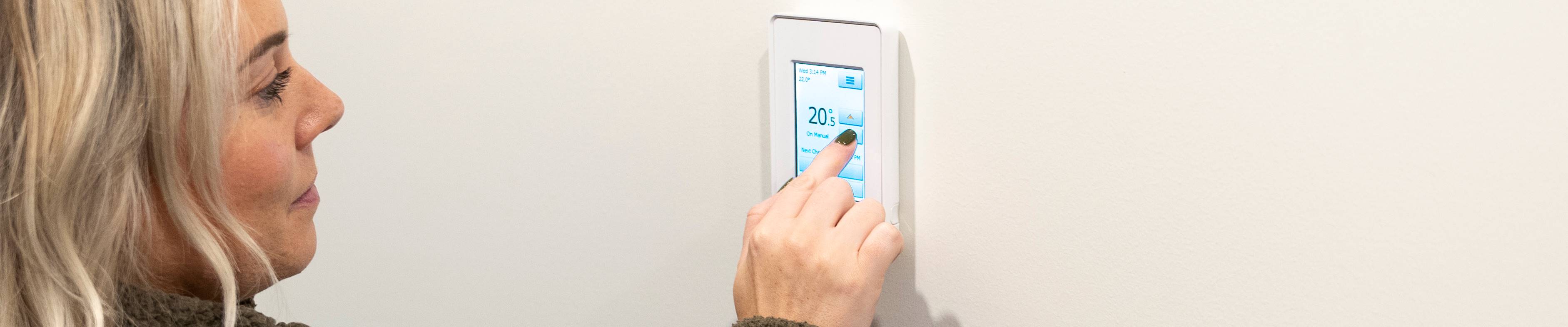 Customer adjusting digital thermostat