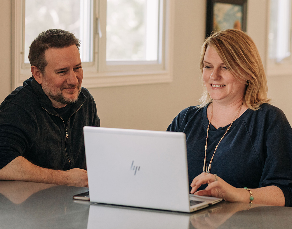 customer and contractor looking at computer at home