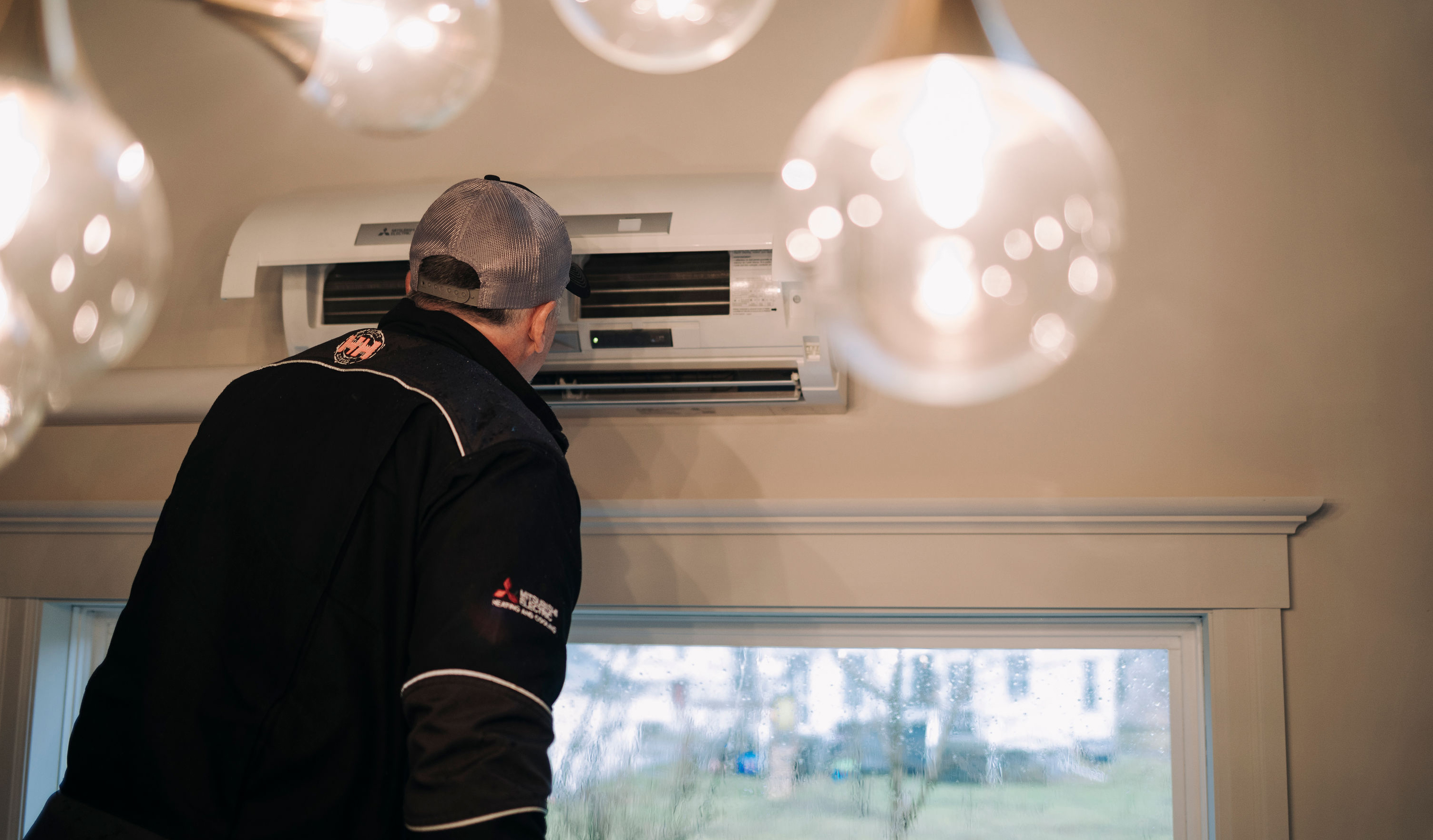 Contractor installing a white heat pump